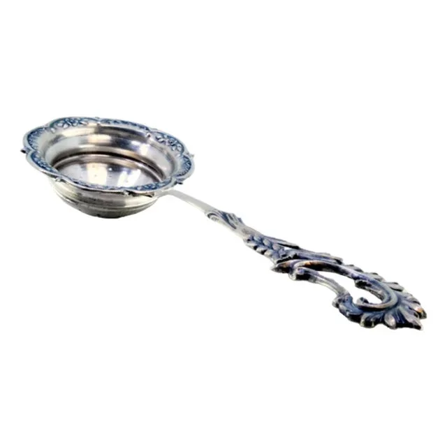 Silver Tea Strainer with Embossed Handle and Floral Motifs